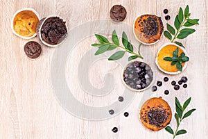 Chocolate muffin and nut muffin, homemade bakery on dark background. Muffin with blueberries on a wooden table.