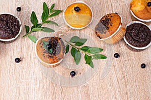 Chocolate muffin and nut muffin, homemade bakery on dark background. Muffin with blueberries on a wooden table.