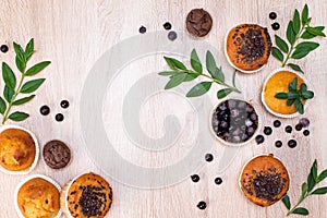 Chocolate muffin and nut muffin, homemade bakery on dark background. Muffin with blueberries on a wooden table.