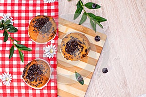 Chocolate muffin and nut muffin, homemade bakery on dark background. Muffin with blueberries on a wooden table.