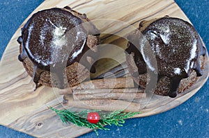 Chocolate muffin on wooden background.