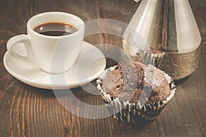chocolate muffins, coffee cup and turks/chocolate muffins, coffee cup and turks on a wooden background. Dark style