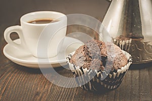 chocolate muffins, coffee cup and turks/chocolate muffins, coffee cup and turks on a wooden background, selective focus
