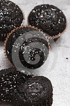 Chocolate muffins on a gray background.
