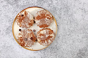 Chocolate muffins with nutmeg and cinnamon on a wooden background, cozy breakfast concept, advertising for a cafe or bakery,