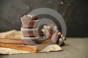 Chocolate muffins with nuts on a wooden table. delicious sweet dessert. rustic style