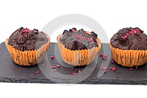 Chocolate muffins on slate plate isolated on white