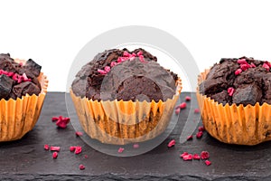 Chocolate muffins on slate plate isolated on white