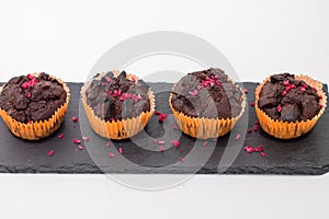 Chocolate muffins on slate plate on white