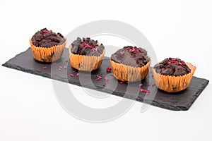 Chocolate muffins on slate plate on white