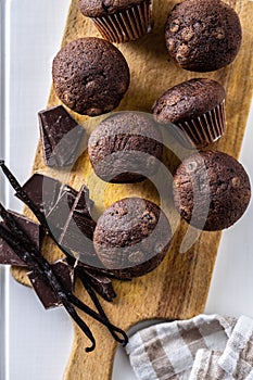 Chocolate muffins. Sweet dark cupcakes with chocolate and vanilla pods