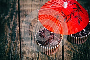 Chocolate muffins under red umbrella