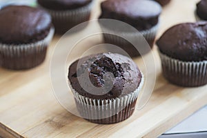 Chocolate muffins on a wooden board