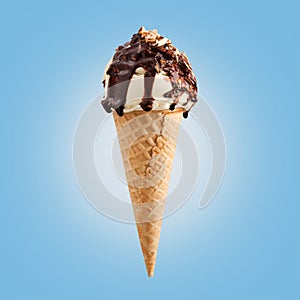 Chocolate nuts ice cream cone on blue background