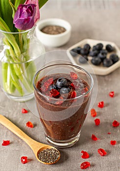 Chocolate oatmeal and chia seeds smoothie glass with blueberries