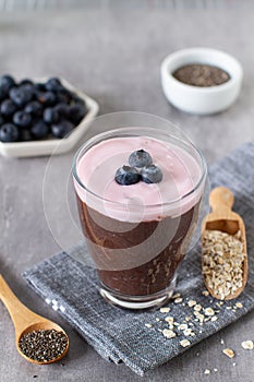 Chocolate oatmeal and chia seeds smoothie glass with blueberries