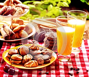 Chocolate oatmeal cookies, sand heart shape cake with orange juice