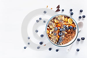 Chocolate oatmeal porridge with blueberry, nuts, banana, dried a