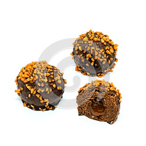 chocolate-orange petit-four cakes with caramel-orange liquid filling isolated on white background.