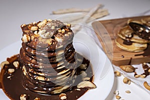 Chocolate pancake with bananas, nuts and chocolate sauce. the toning. Top view