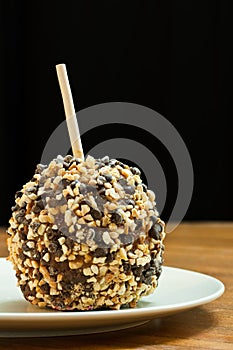 Chocolate and peanut covered candy apple