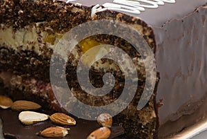 Chocolate pie with almonds and a cream stuffing in