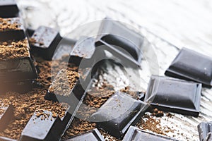 Chocolate pieces. Chopped dark chocolate closeup on wooden background