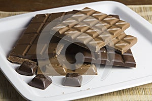 Chocolate peces on white plate photo