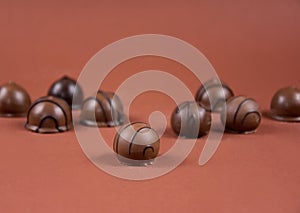 Chocolate pralines on a brown background stock images