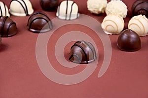 Chocolate pralines on a brown background stock images