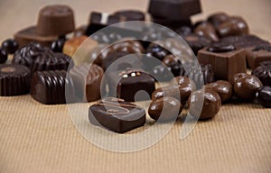 Chocolate pralines on a brown background stock images