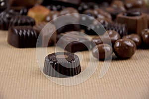 Chocolate pralines on a brown background stock images