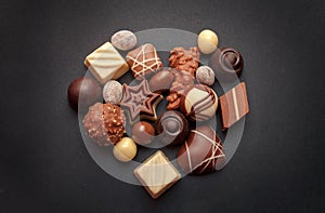 Chocolate pralines on dark background