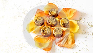 Chocolate pralines with flower on white