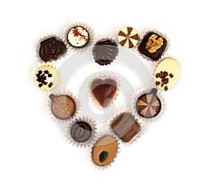 Chocolate pralines in heart shape on a white background