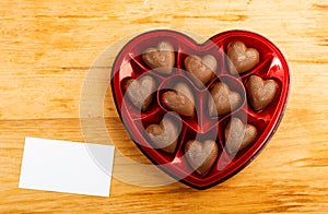 Chocolate pralines in red heart shape box