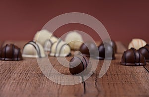 Chocolate pralines on a wooden background stock images