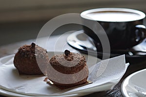 Chocolate profitroles cakes with a cup of coffee.