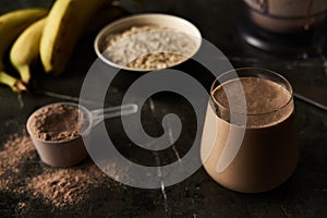 Chocolate Protein Power Cocktail with Ripe Bananas, Whole Oats, and Creamy Milk in a Modern Glass, Ideal for Post