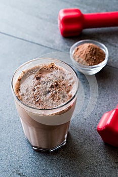 Chocolate Protein Shake Smoothie with Whey Protein Powder and Red Dumbbells