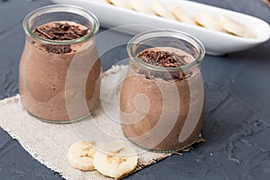 Chocolate pudding with chia seed, bananas and nuts, in a glass