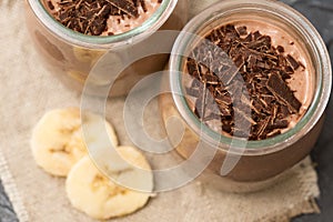 Chocolate pudding with chia seed, bananas and nuts, in a glass