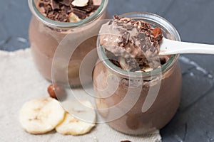 Chocolate pudding with chia seed, bananas and nuts, in a glass