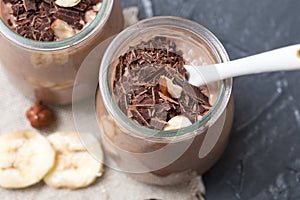 Chocolate pudding with chia seed, bananas and nuts, in a glass