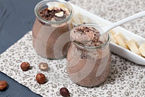 Chocolate pudding with chia seed, bananas and nuts, in a glass