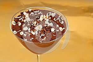 Chocolate pudding with chocolate curls in a martini glass