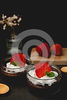 Chocolate pudding with cream and strawberry. Sweet dessert and home cooking