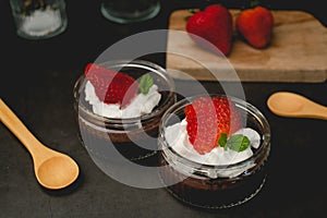 Chocolate pudding with cream and strawberry. Sweet dessert and home cooking. vertical