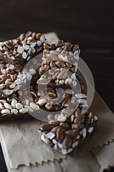 Chocolate with puffed rice bar on wooden table