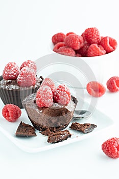 Chocolate raspberry mousse filled cups on a serving platter.